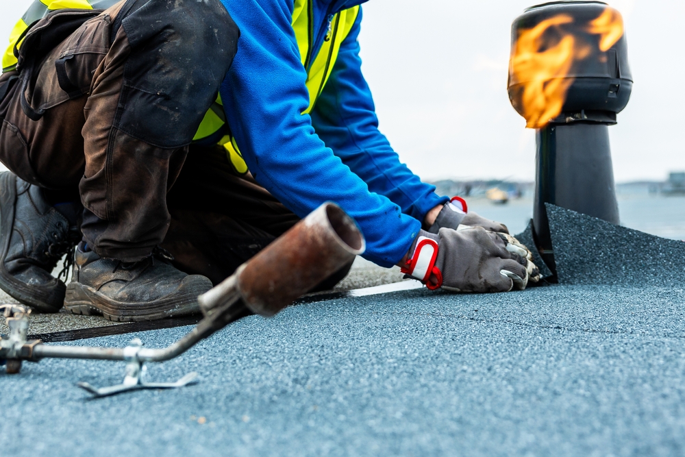 A,Worker,In,A,High,Visibility,Vest,Kneels,On,A